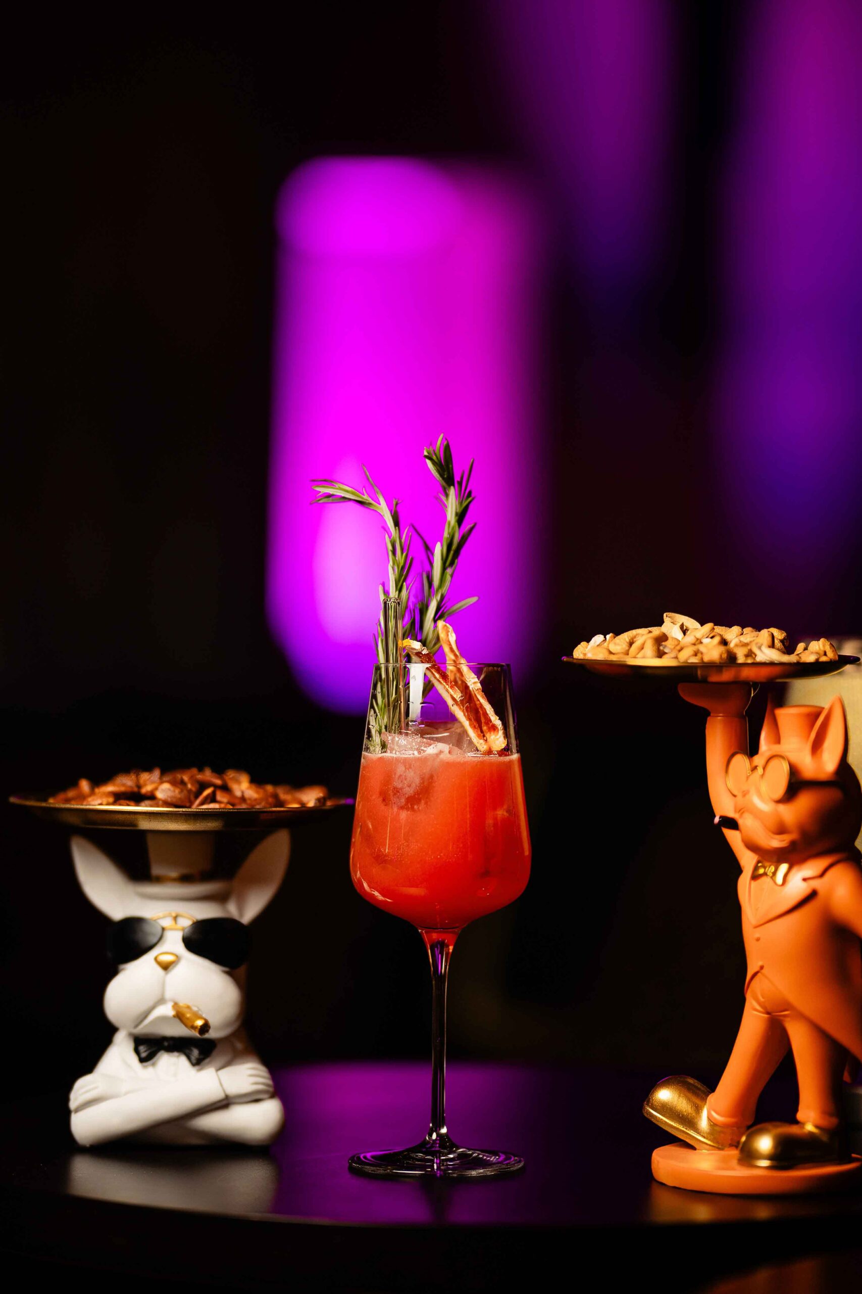 Red cocktail and snacks